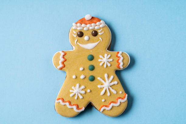 istock Christmas Gingerbread angel shape isolated on blue background. Flat lay. 1312179373