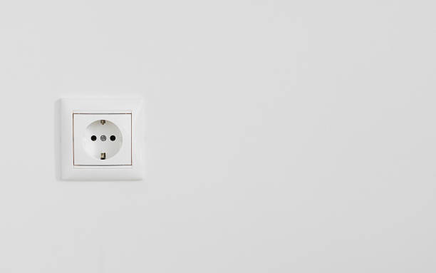 istock White electrical outlet on white plastered wall, close-up with copy space 1312179464