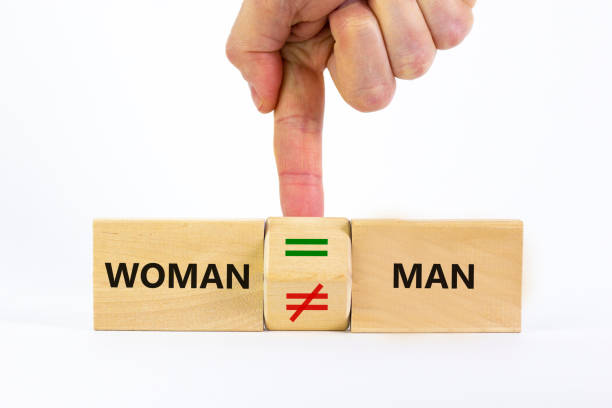istock Symbol for gender equality. Businessman turns a cube and changes a unequal sign to a equal sign between men and women. Beautiful white background, copy space. Gender equality concept. 1312180461