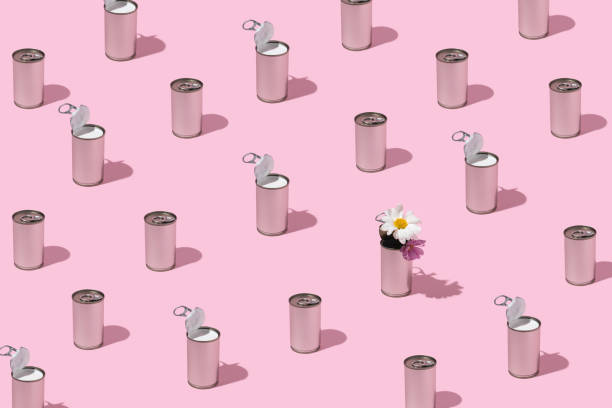 Silver cans pattern. Cans with flowers and coconut milk on pastel pink background. Retro scene.