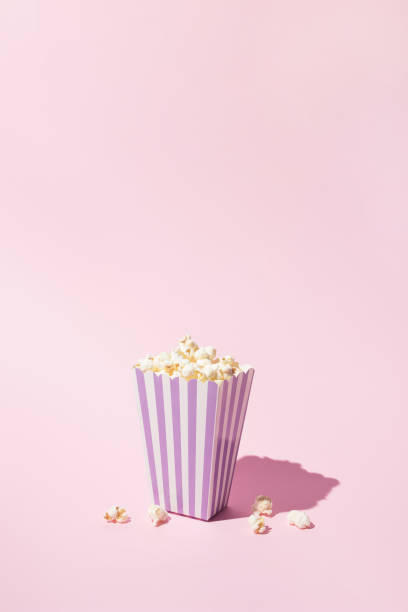 istock Pop corn striped box for a movie night. Retro scene in pastel colors. 1312181597