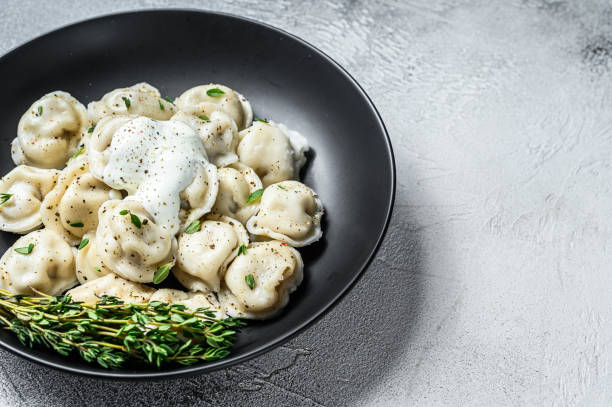 Italian ravioli dumplings with meat. White background. top view. Copy space Italian ravioli dumplings with meat. White background. top view. Copy space. russian pelmeni stock pictures, royalty-free photos & images