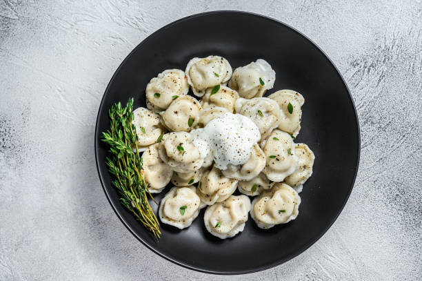Italian ravioli dumplings with meat. White background. top view Italian ravioli dumplings with meat. White background. top view. russian pelmeni stock pictures, royalty-free photos & images