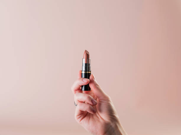 istock A woman's hand holds a new open lipstick 1312183720