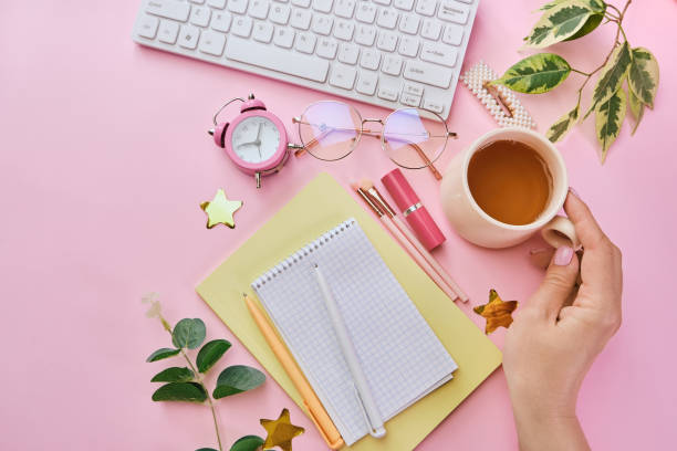 istock Women table with coffee, office supplies, pink makeup brushes 1312183784