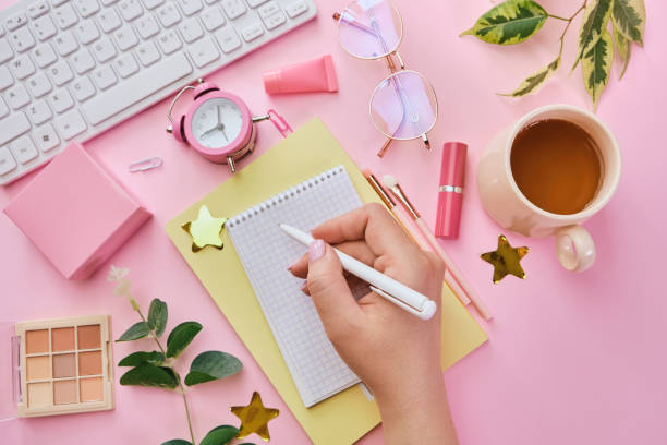istock Women table with coffee, office supplies, pink makeup brushes 1312184207