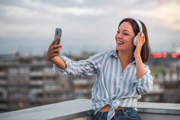 istock Young woman on the rooftop enjoying the sunset 1312184255