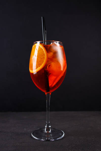 istock Glass of Spritz cocktail on black background 1312185579