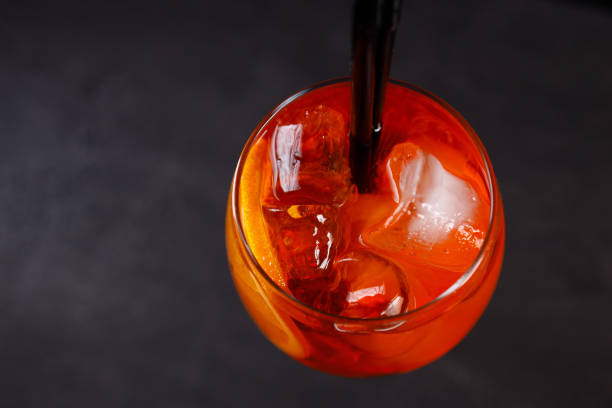 Glass of Spritz cocktail on black background