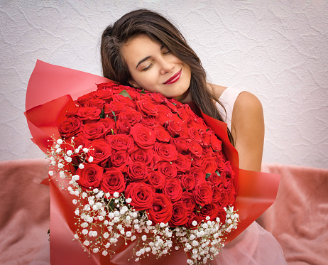young girl with a bouquet of red roses, happy girl close up