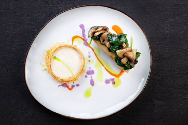 istock Chicken breasts with cheese and vegetable garnish 1312187619