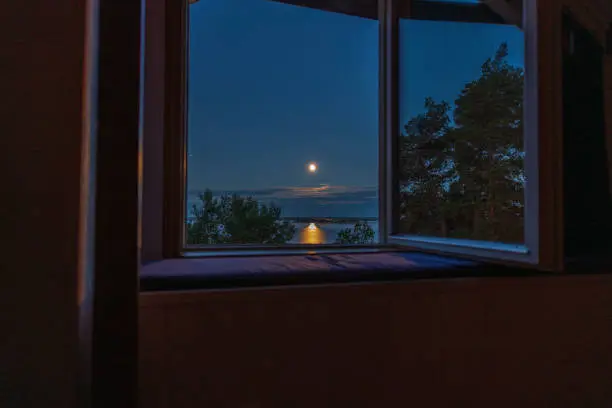 Photo of Gorgeous view of sunset trough open window. Sweden.
