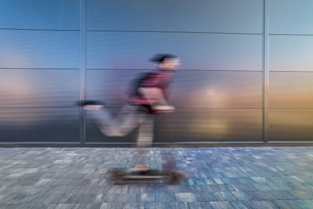 istock A young man on his e-scooter. Technology, ecological concept of mobility. A hipster young man riding an electric scooter. 1312189958