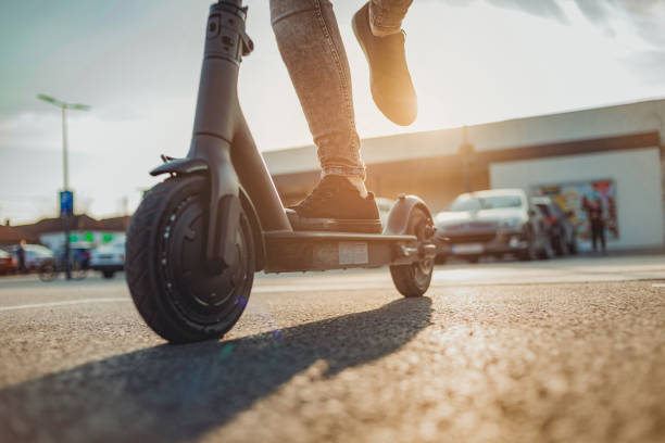 istock Young man on his e-scooter, pushing off and starting. Technology, ecological concept of mobility. A hipster young man riding an electric scooter. 1312190020