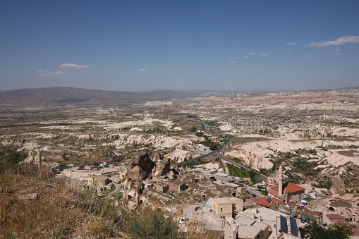 Cappadocia, Nevsehir, Turkey-May 17, 2014: Panoramic view from Uchisar, the biggest fairy chimney of Cappadocia. Fairy chimneys are a structure formed by rain, wind and flood waters eroding the structures made of tuffs.