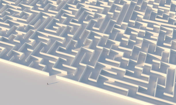 istock Businessman looking at maze entrance 1312191606