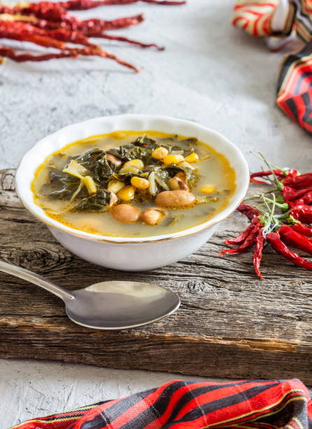 istock Collard greens soup with corns and kidney beans in white seramic bowl on rustic background 1312192074