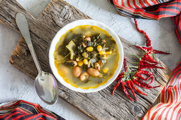 istock Collard greens soup with corns and kidney beans in white seramic bowl on rustic background 1312192481