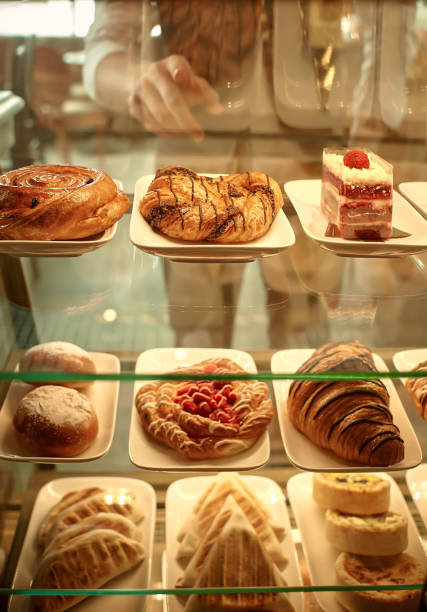 a woman in a cafe chooses sweets, cakes.