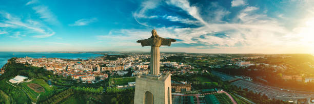 Aerial panoramic view of Sanctuary of Christ the King or Santuario de Cristo Rei at sunset. Christ Statue in Lisbon, Portugal. Aerial panoramic view of Sanctuary of Christ the King or Santuario de Cristo Rei at sunset. Christ Statue in Lisbon, Portugal. High quality photo cristo redentor rio de janeiro stock pictures, royalty-free photos & images
