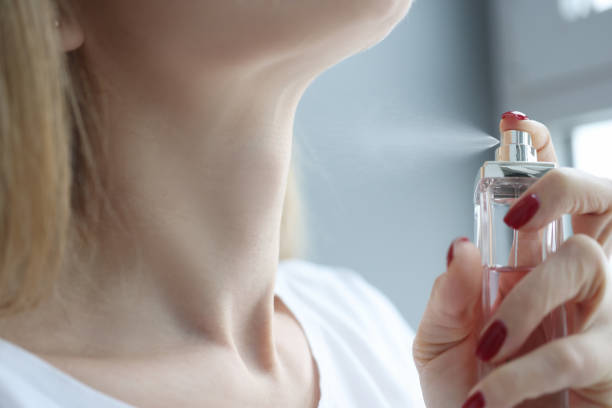 istock Woman sprinkling perfume on her neck closeup 1312202330