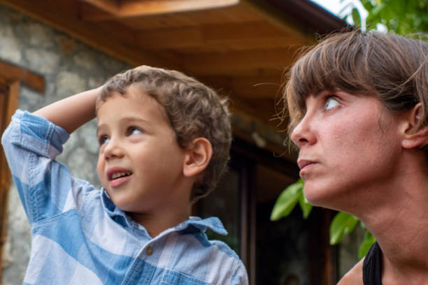 istock Mother and her son (4-5) together in garden 1312203277
