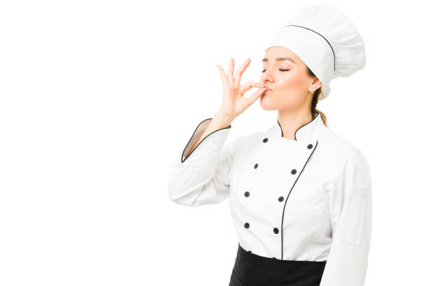 Professional cook feeling satisfied with her new menu Young woman working as a restaurant chef and telling she just made a delicious dinner. Proud female cooker kissing her fingers chefs whites stock pictures, royalty-free photos & images