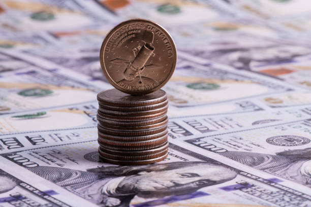 istock 1 US dollar coin depicting a space telescope and 100 dollar bills 1312207025