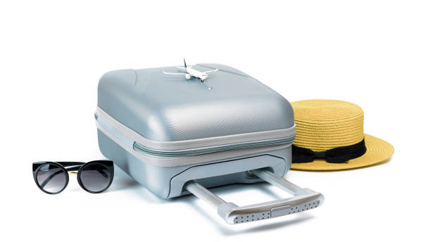 istock Summer pattern background. Suitcase, sunglasses with toy plane and straw hat in travel composition isolated on white background. Design of summer vacation holiday with copy space. 1312207937