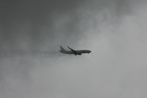 salvador, bahia, brazil - may 3, 2013: Boeing 737 of the airline Gol goes through a rain cloud during the landing procedure at the airport in the city of Salvador.