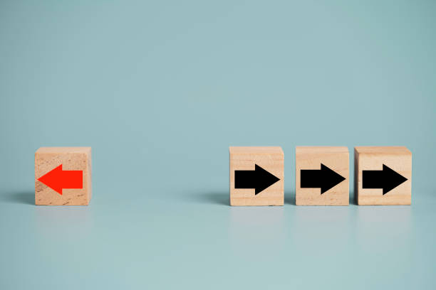 istock Red arrow print screen on wooden block change direction from right to left which differ from black arrows , Business and technology disruption concept. 1312210947