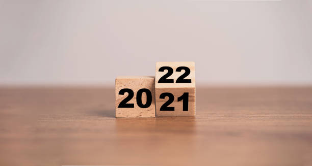 Flipping of wooden cubes block to change 2021 to 2022 year. Merry Christmas and happy new year concept. Flipping of wooden cubes block to change 2021 to 2022 year. Merry Christmas and happy new year concept. flip calendar stock pictures, royalty-free photos & images