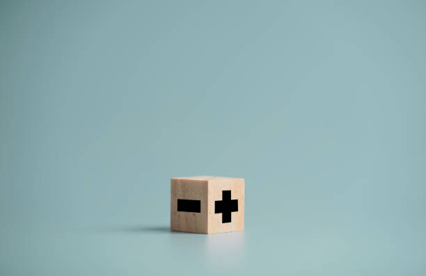 istock Plus and minus sign in opposite side which print screen on wooden cube block and copy space, positive mindset selection concept. 1312211499