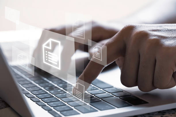 istock Hand with document icons and  typing to laptop computer. 1312213853