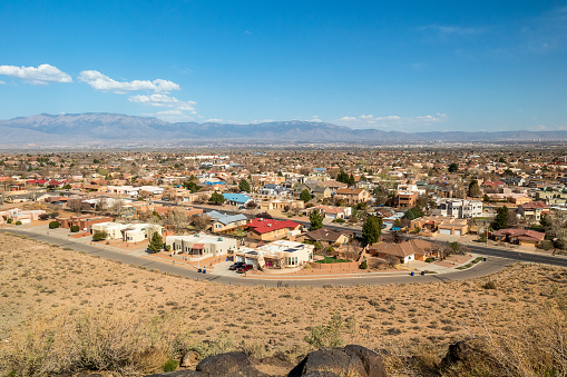 Southwest living. Albuquerque Metro Area Residential Panorama with the view of Sandia Mountains on the distance. Petroglyph National Monument, New Mexico