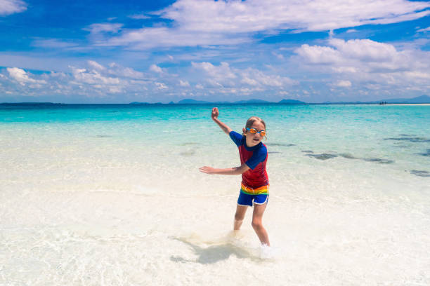 istock Kids playing on beach. Children play at sea. 1312226996