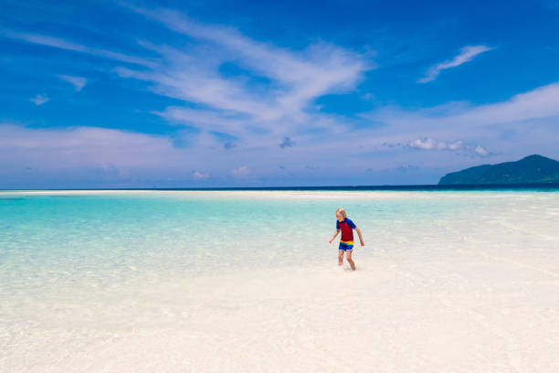istock Kids playing on beach. Children play at sea. 1312227014