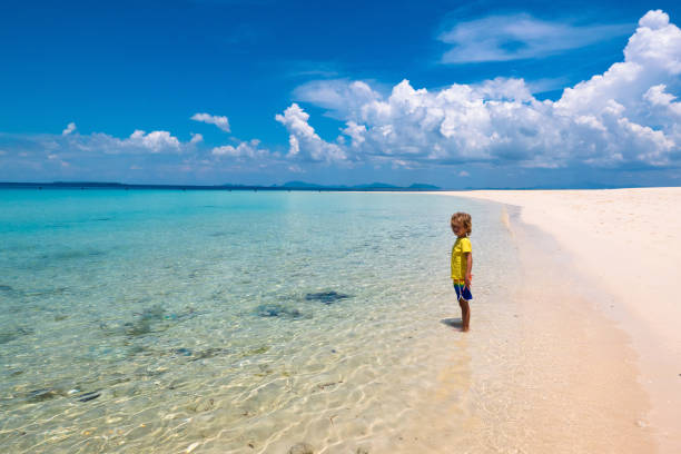 istock Kids playing on beach. Children play at sea. 1312227926