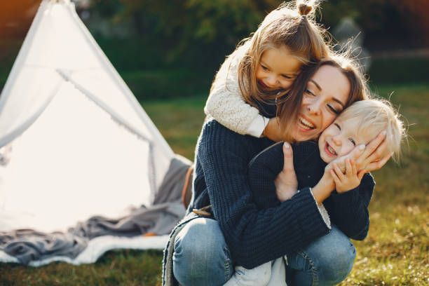 istock Mother with children playing in a summer park 1312228758