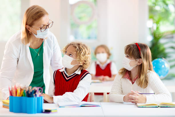 istock Kids in face mask. Child in school. 1312230792
