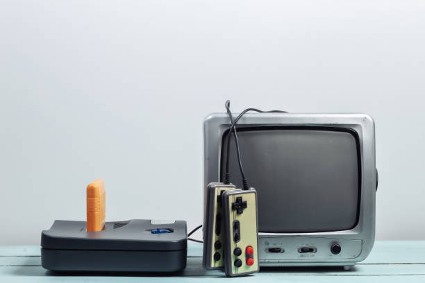 istock Old tv receiver with retro game console, joysticks on a white wall background. Retro gaming. 80s 1312233517