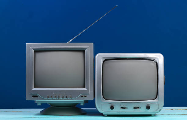 istock Two Old tv receiver on classic blue background. Retro media 1312233620