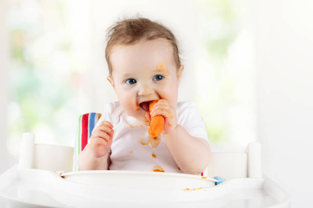 istock Baby eating vegetables. Solid food for infant. 1312234805