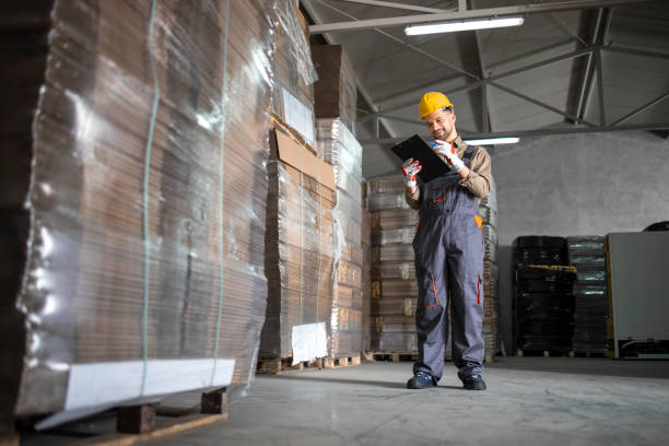 istock Warehouse worker checking inventory in storehouse storage department. 1312235947