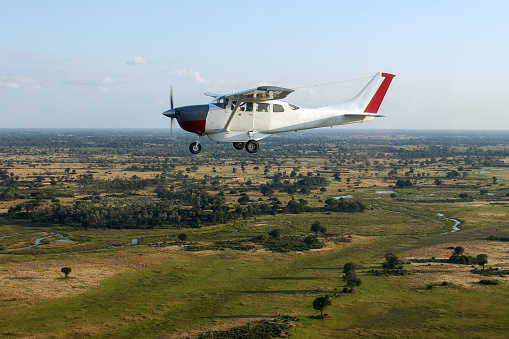 Aerial images of the Okavango Delta in Botswana. In the image you can see another aeroplane flying tourist over the Delta.