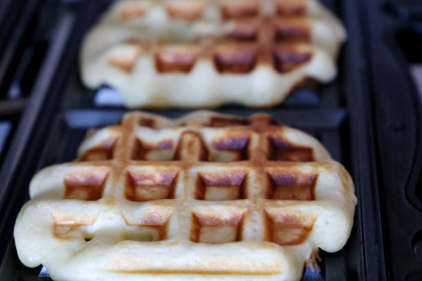 istock Belgian waffles in electric waffle iron 1312241368