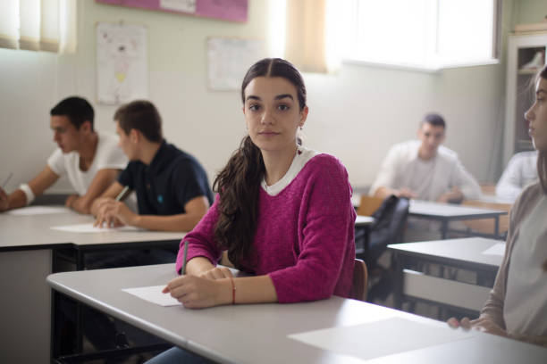 istock Teenagers students sitting in the classroom and writing. 1312241409