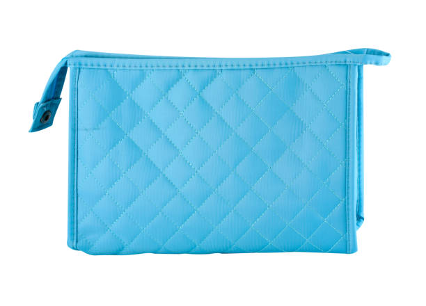 Blue toiletries bag with zipper Blue make-up bag with diamond seams pattern, white background, clipping path make up bag stock pictures, royalty-free photos & images