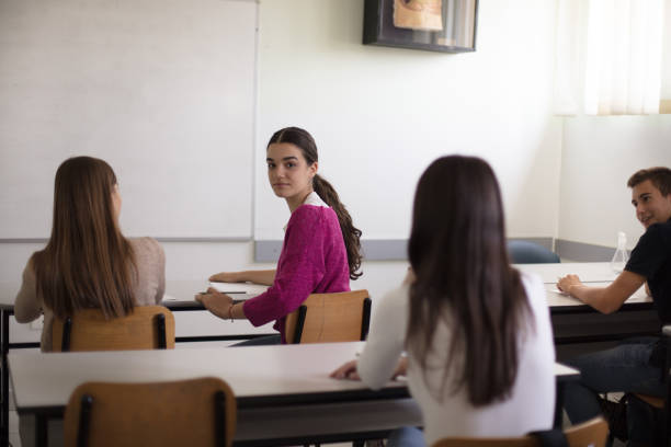 istock Teenagers students sitting in the classroom working exam. 1312241492