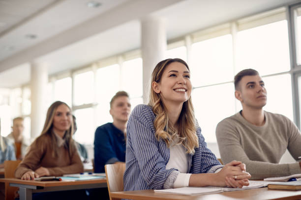 Group of happy college students listening lecture in the classroom. Happy female student and her friends having a class at the university, high school student classroom education student stock pictures, royalty-free photos & images